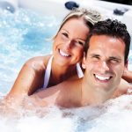 Couple enjoying a luxury hot tub in the garden